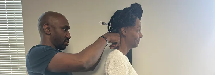 Dr. Cooley examining a patient's neck prior to an adjustment
