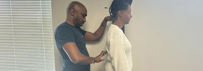 Dr. James Cooley examining a patient's back following an injury