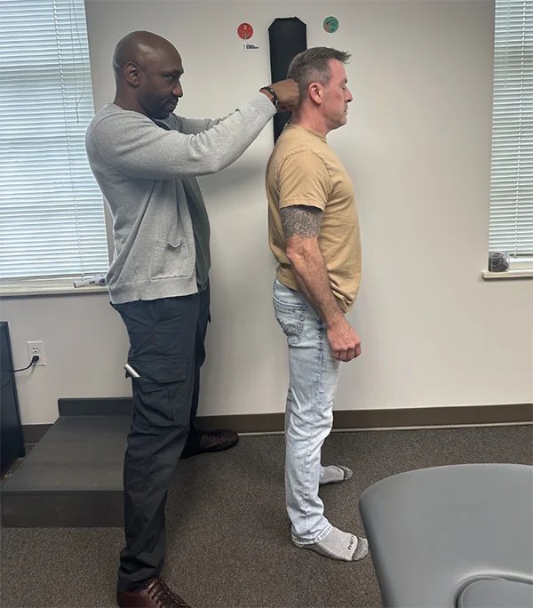Dr. James Cooley examining a patient's posture