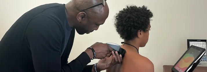 Dr. Cooley using an Insight scanner on a patient's shoulder
