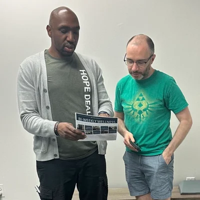 Dr. James Cooley and a patient discussing treatment while referencing a pamphlet