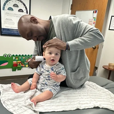 Dr. James Cooley examining a pediatric patient